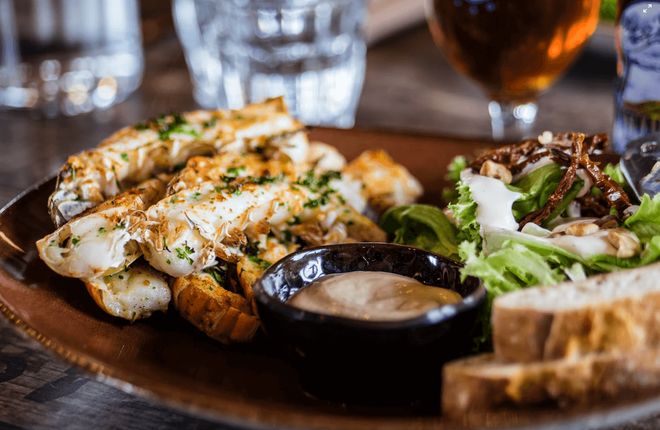 Bread, hummus, and salad on a plate.