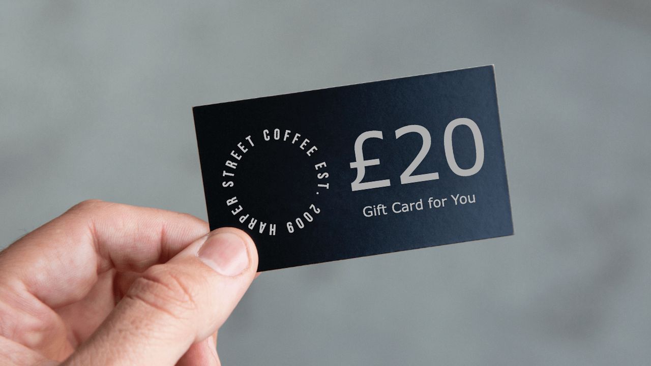 Close-up photo of a black £20 gift card being held by its corner