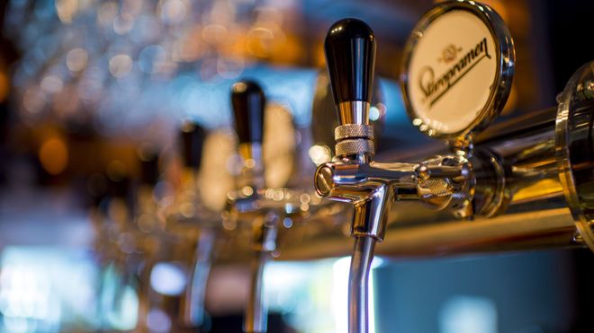 Close-up photo of beer taps in a bar