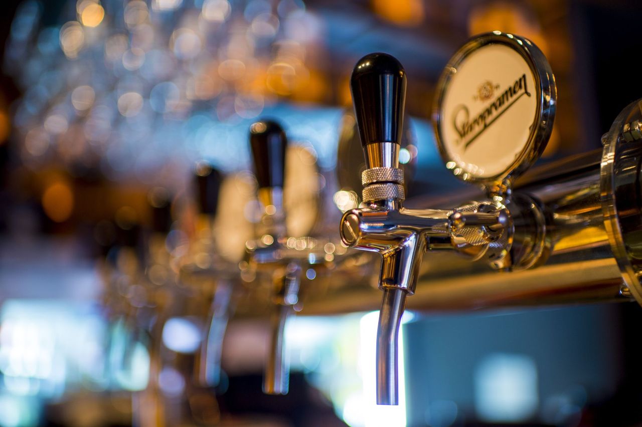 Close-up photo of beer taps in a bar