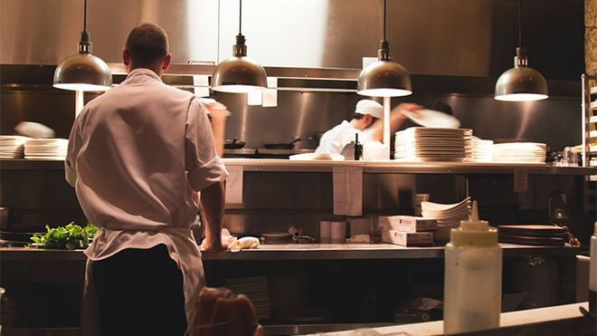 Photo of a kitchen pass-over with kitchen staff on either side