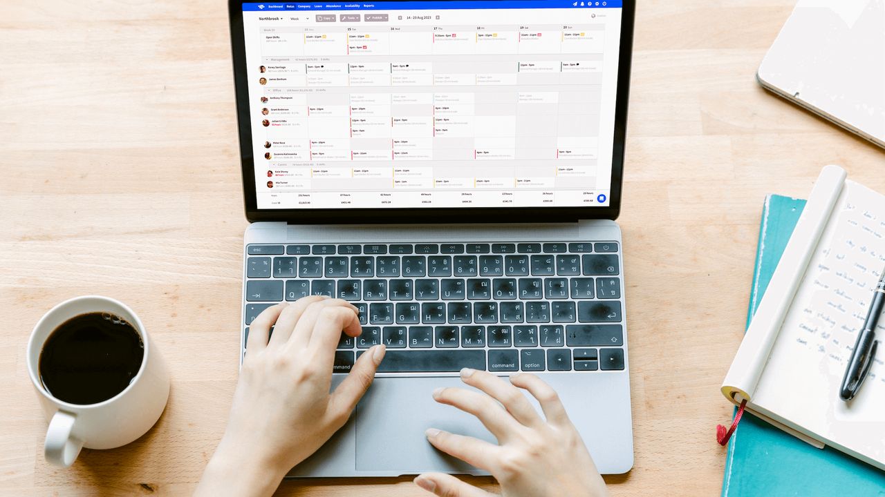 Top-down photo of pair of hands using a laptop computer running RotaCloud