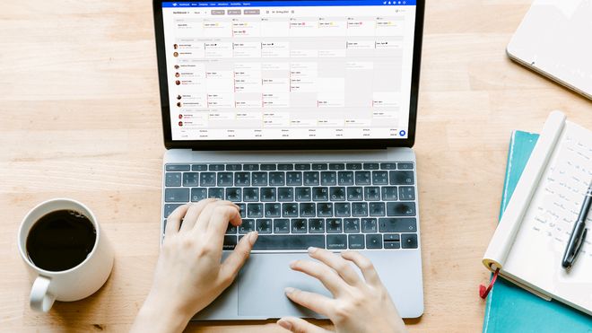 Top-down photo of pair of hands using a laptop computer running RotaCloud