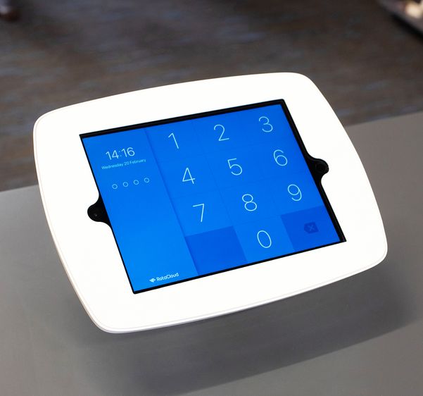 A tablet being used as a RotaCloud clocking in terminal in a workplace. The numbers used for entering the employee's pin, plus the current time are clearly displayed.