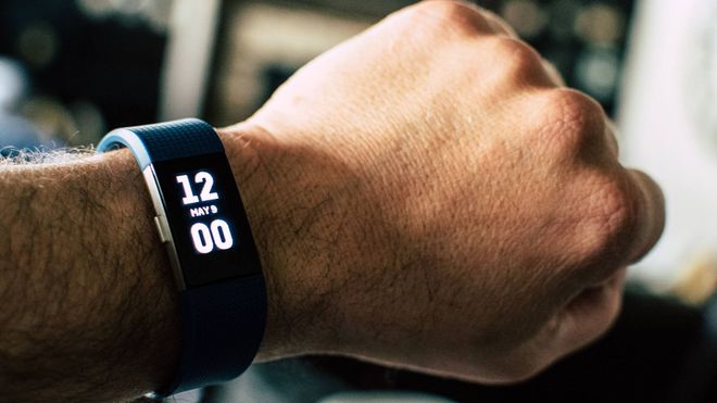 Slimline digital watch on male wrist displaying 12:00 on May 9