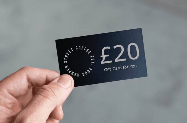 Close-up photo of a black £20 gift card being held by its corner